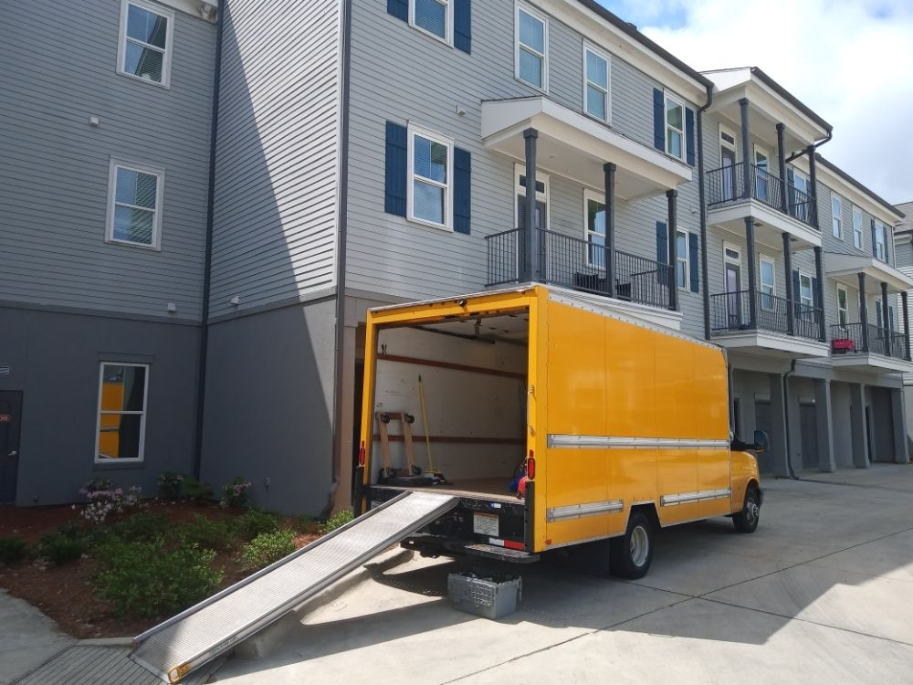 Yellow moving truck at apartment